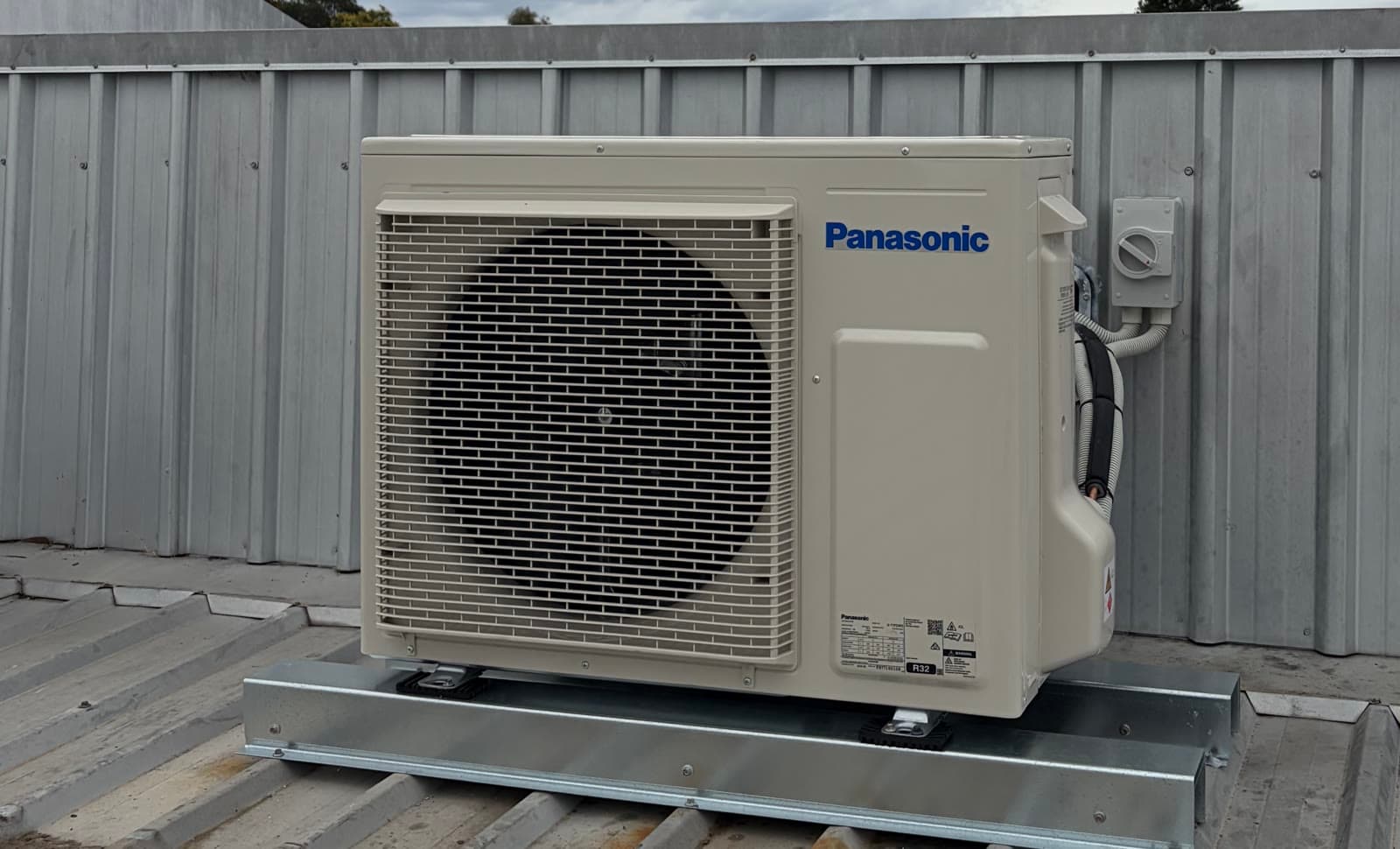 A Panasonic outdoor unit on a commercial metal roof, our previous work