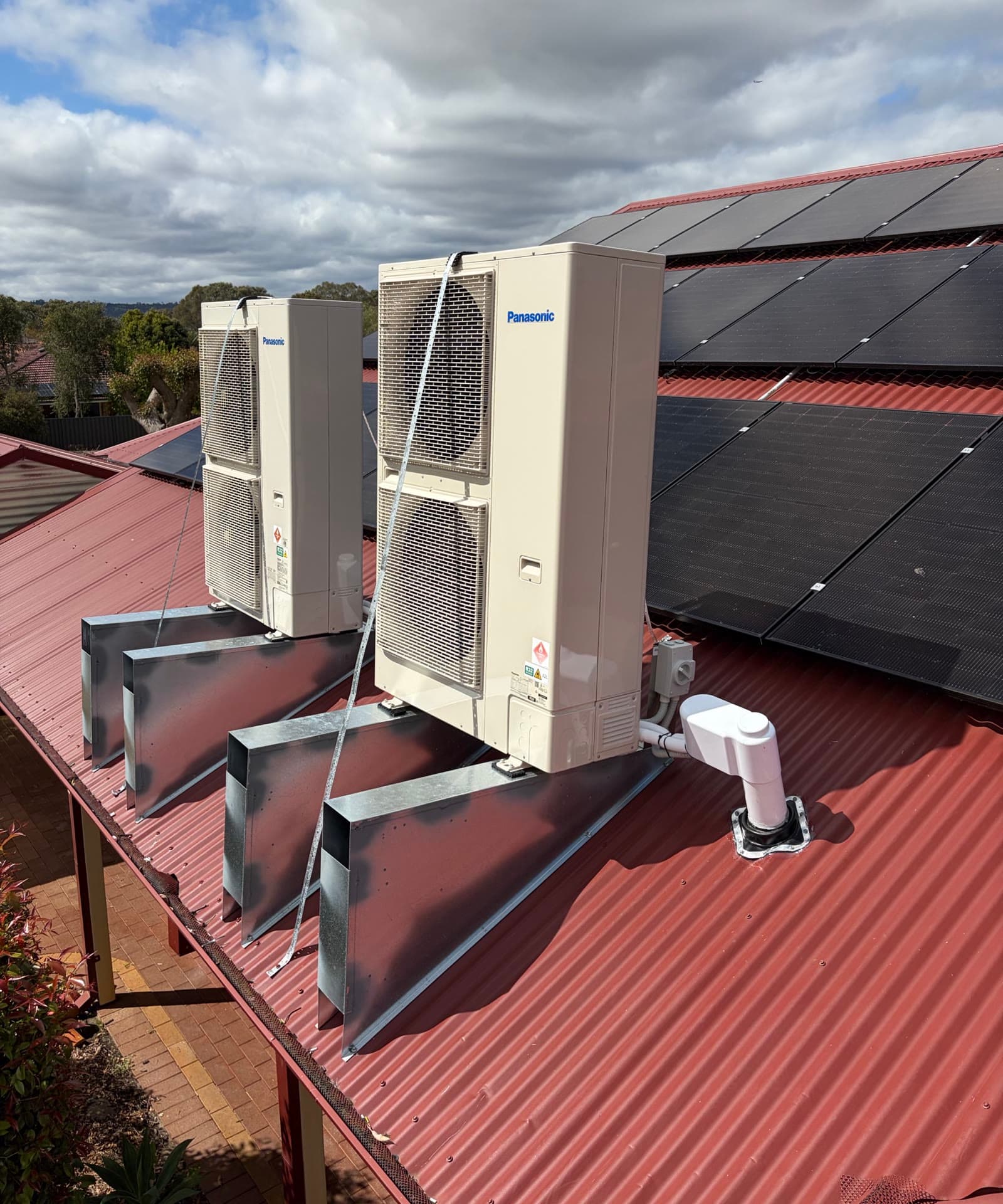 Two Panasonic ducted outdoor units on flashed roof stands, with the pipe covers finished, our previous work